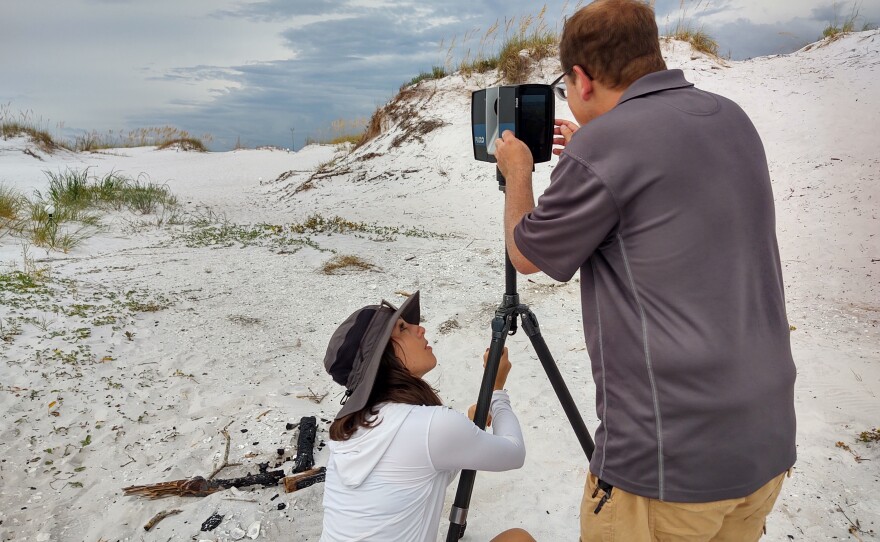 Image 1. FPAN’s Nicole Grinnan and UWF graduate student Jeffery Robinson conduct initial set-up the TLS unit, which includes leveling the device prior to each scan. (Photo courtesy of Sandra Averhart, WUWF Public Media)